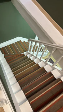 A collection of colorful carpet stair treads in a staircase.