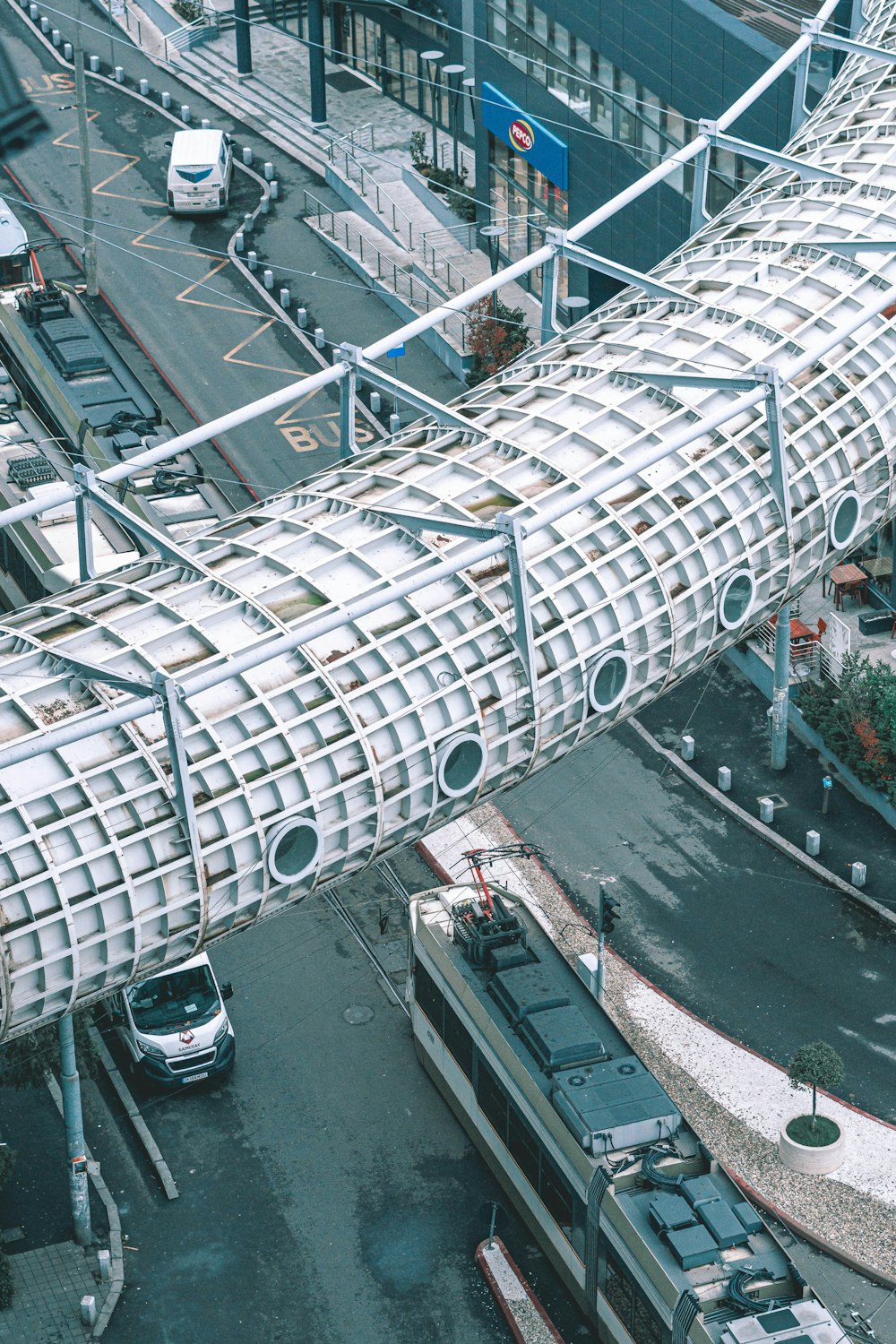 a large metal structure sitting on the side of a road