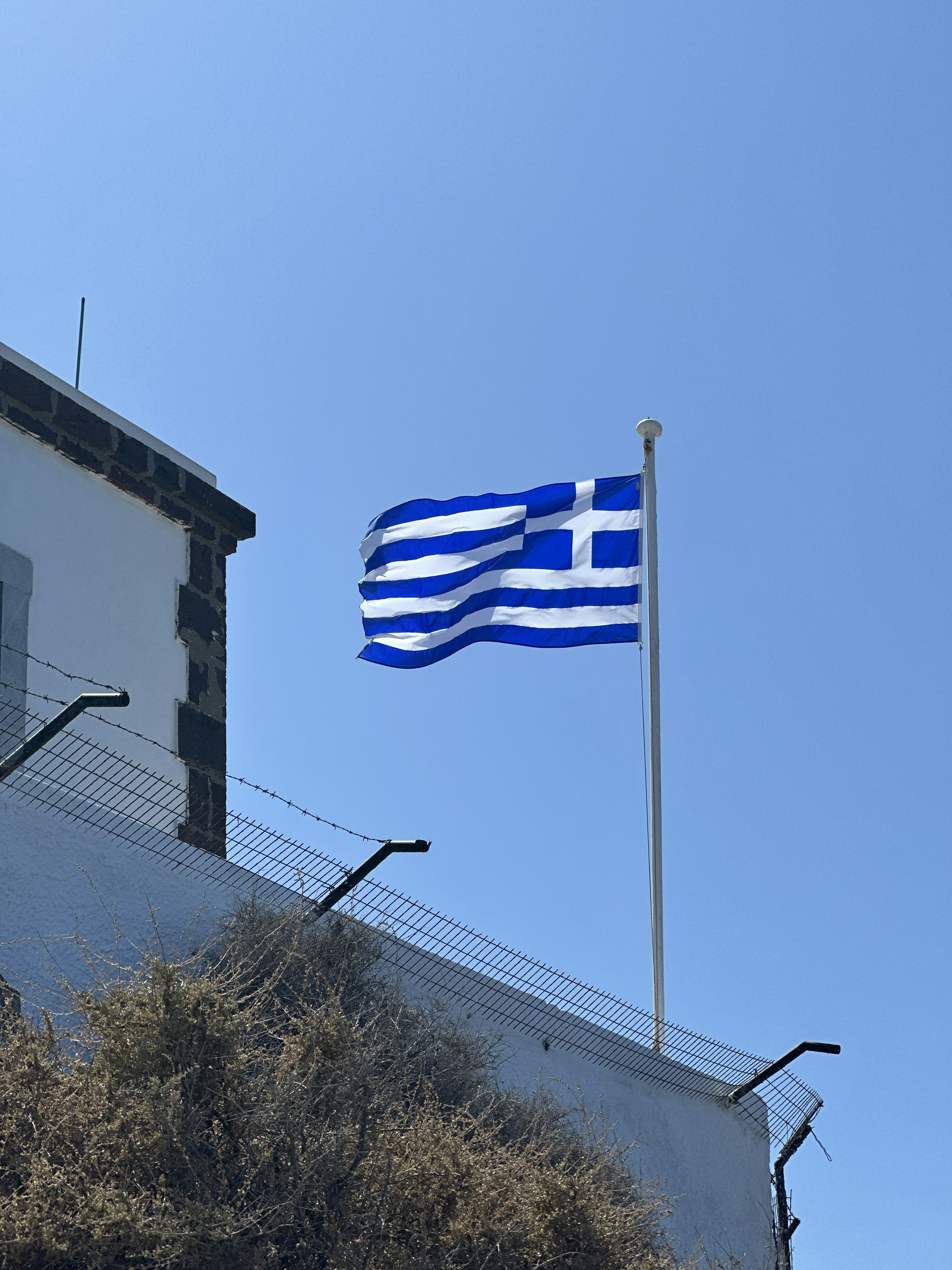 a flag flying on top of a building