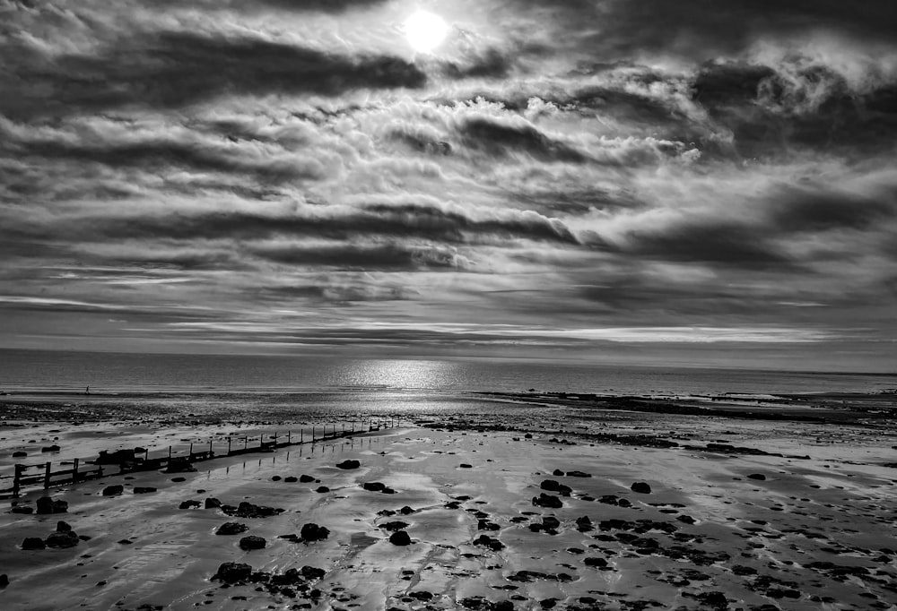 a black and white photo of a beach