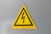 a yellow triangle sign with a lightning bolt on it