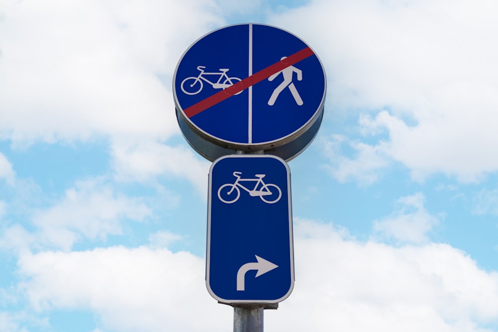 a blue street sign with a bike on it