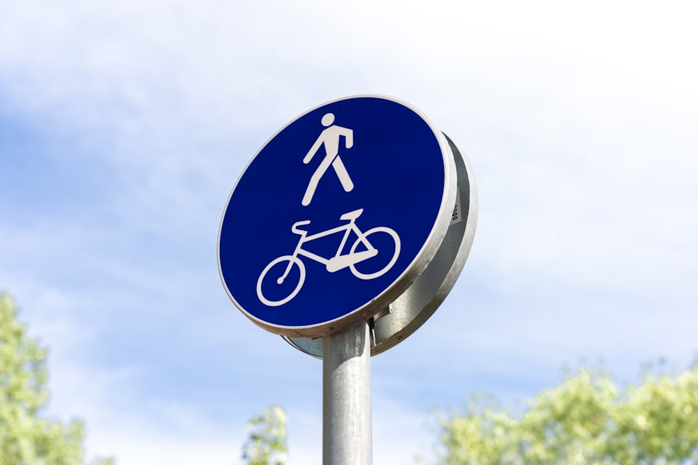 a blue sign with a picture of a man riding a bike