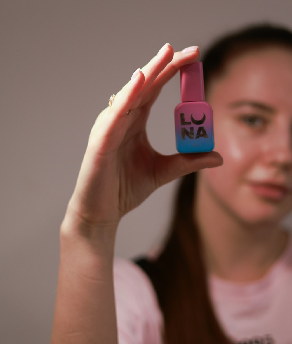 a woman holding up a cell phone in her hand