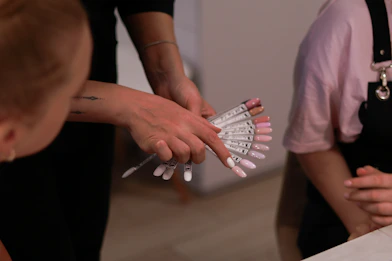 a woman holding a bunch of nails in her hands