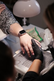 a woman getting her nails done at a salon