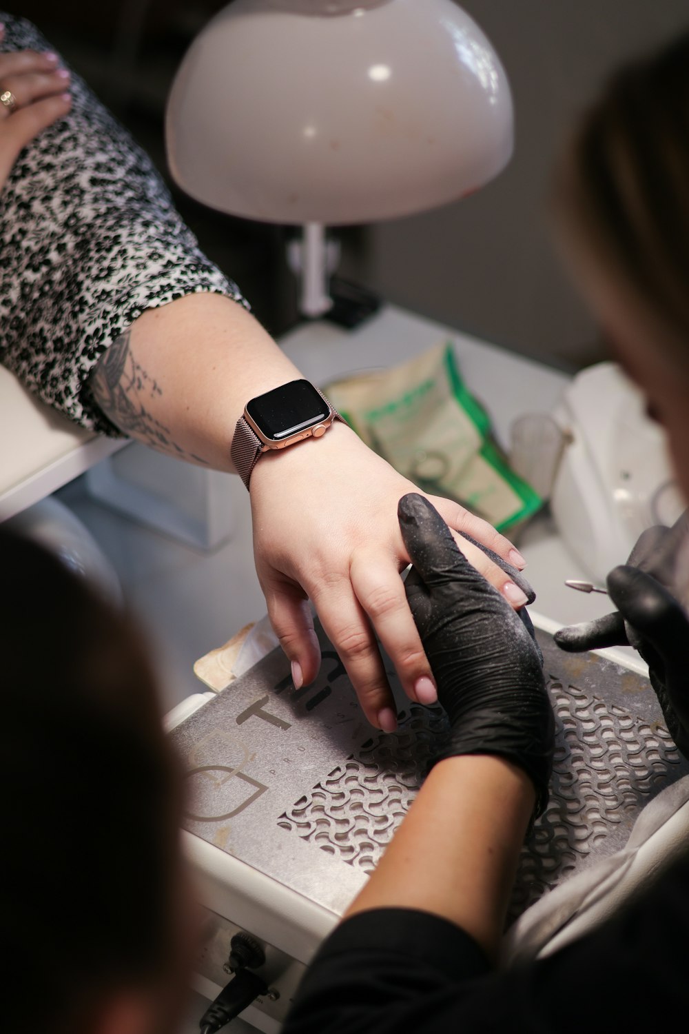 a woman getting her nails done at a salon