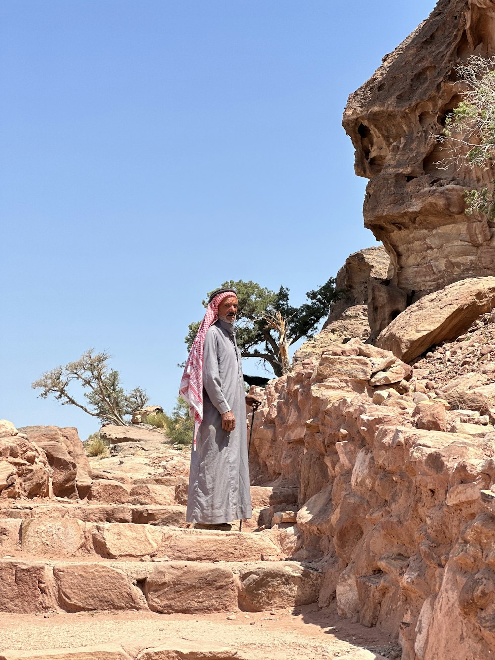 a man is standing on some steps in the desert