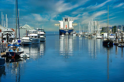 a harbor filled with lots of boats under a cloudy blue sky
