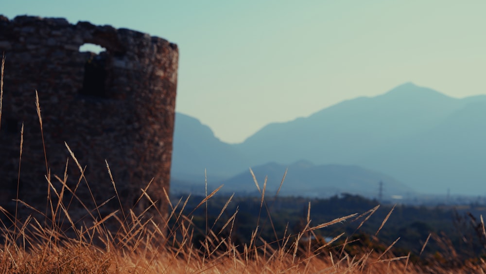 a stone tower sitting in the middle of a field