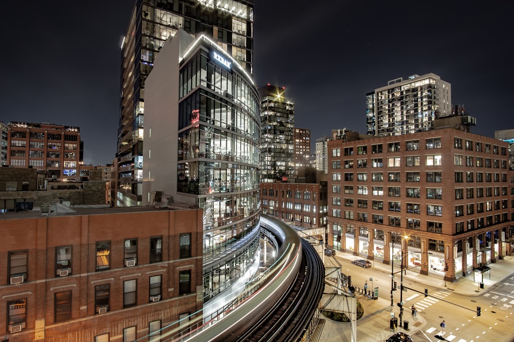 a city at night with a train passing by