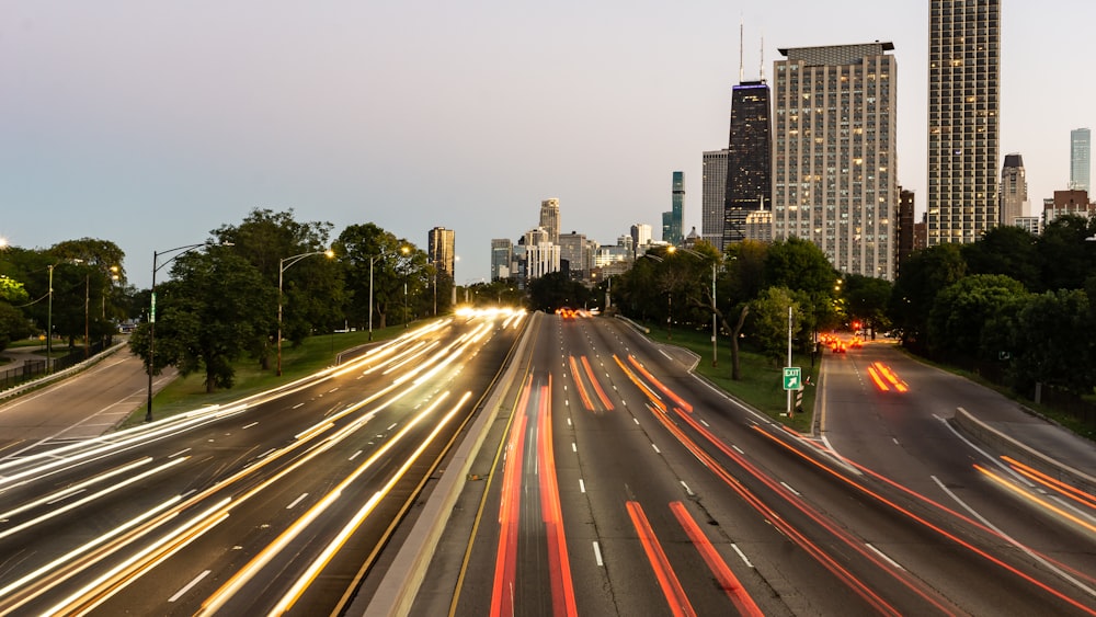 a city street filled with lots of traffic next to tall buildings