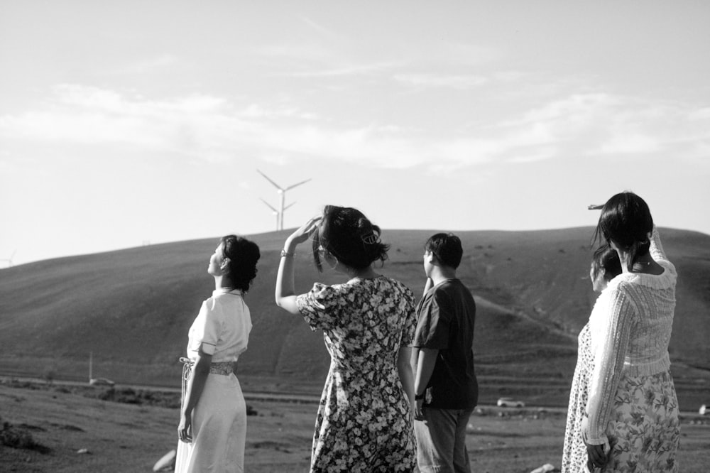 a group of people standing on top of a hill