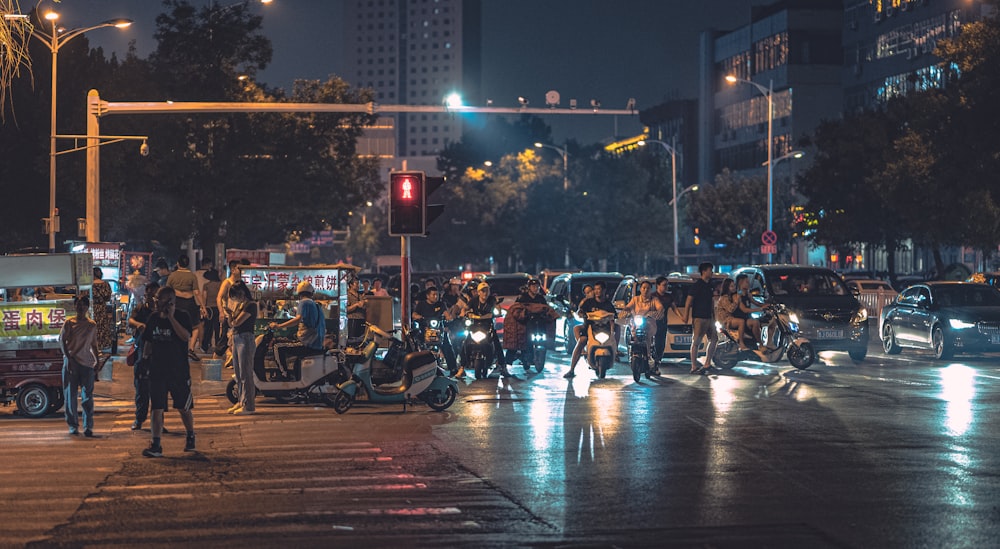 a group of people standing on the side of a road