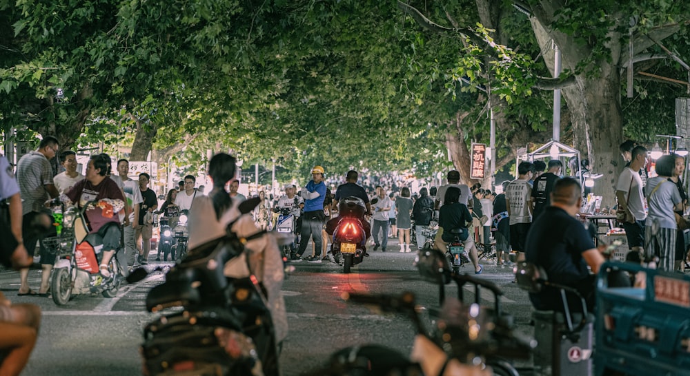 a group of people riding bikes down a street