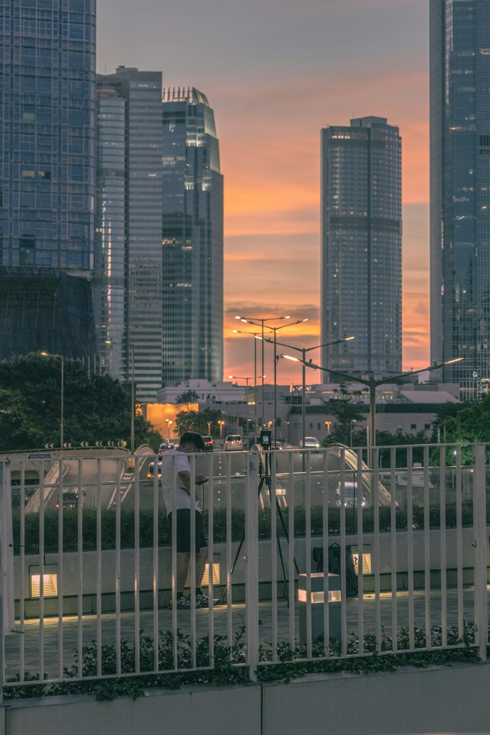 a man riding a skateboard down a street next to tall buildings