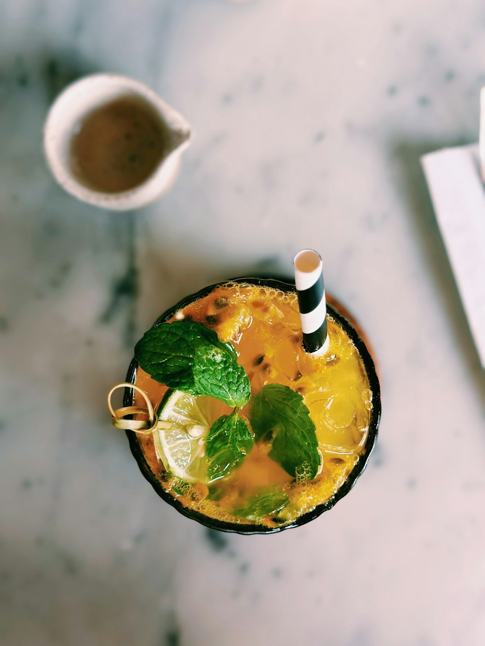 a drink in a glass with a striped straw