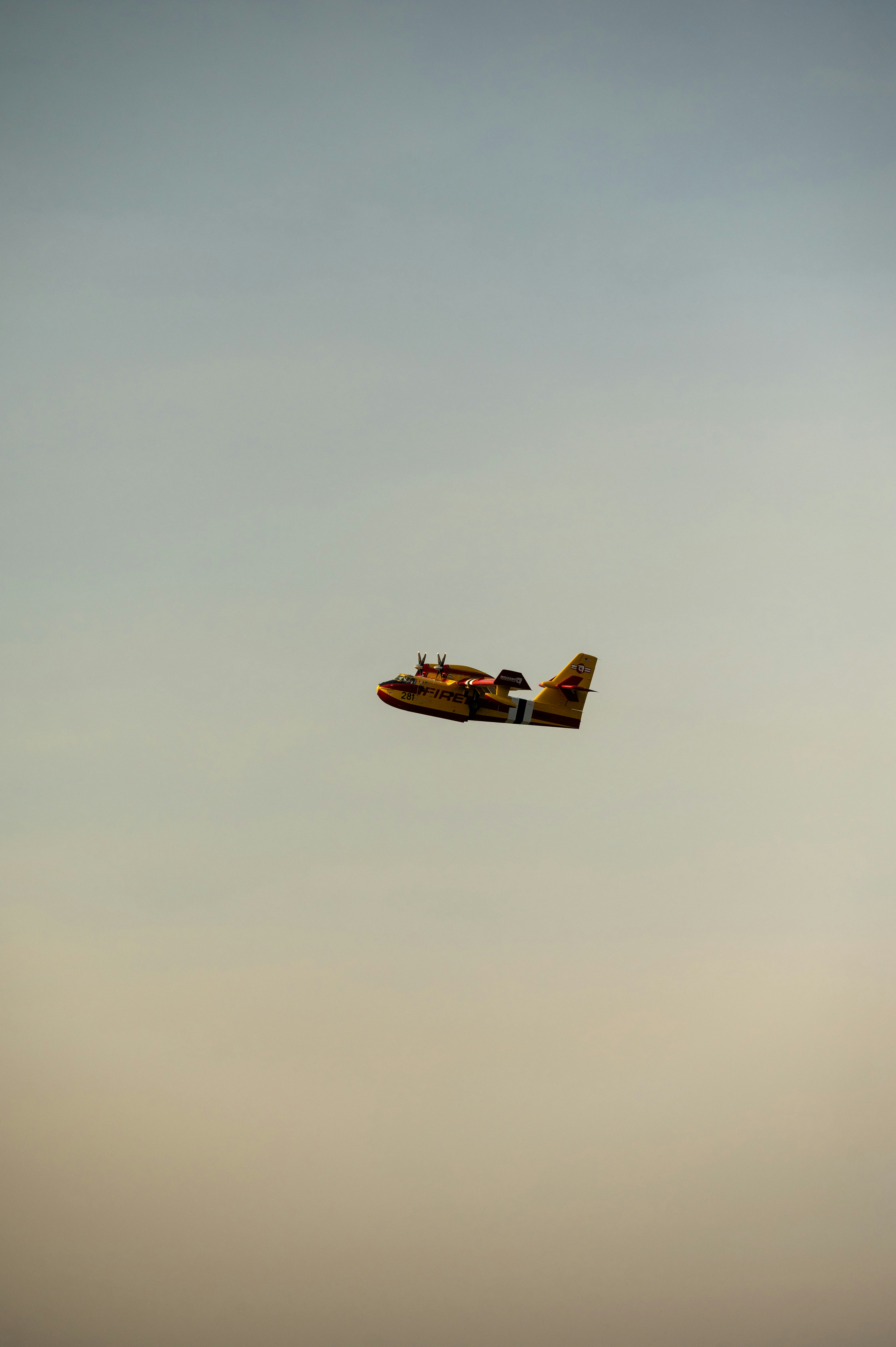 a small airplane flying through a cloudy sky