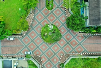 A wide-angle view of a corporate courtyard with symmetrical planting and sleek benches.