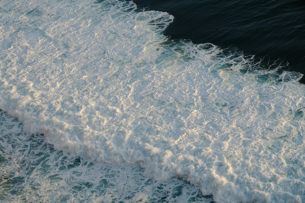 a man riding a surfboard on top of a wave in the ocean