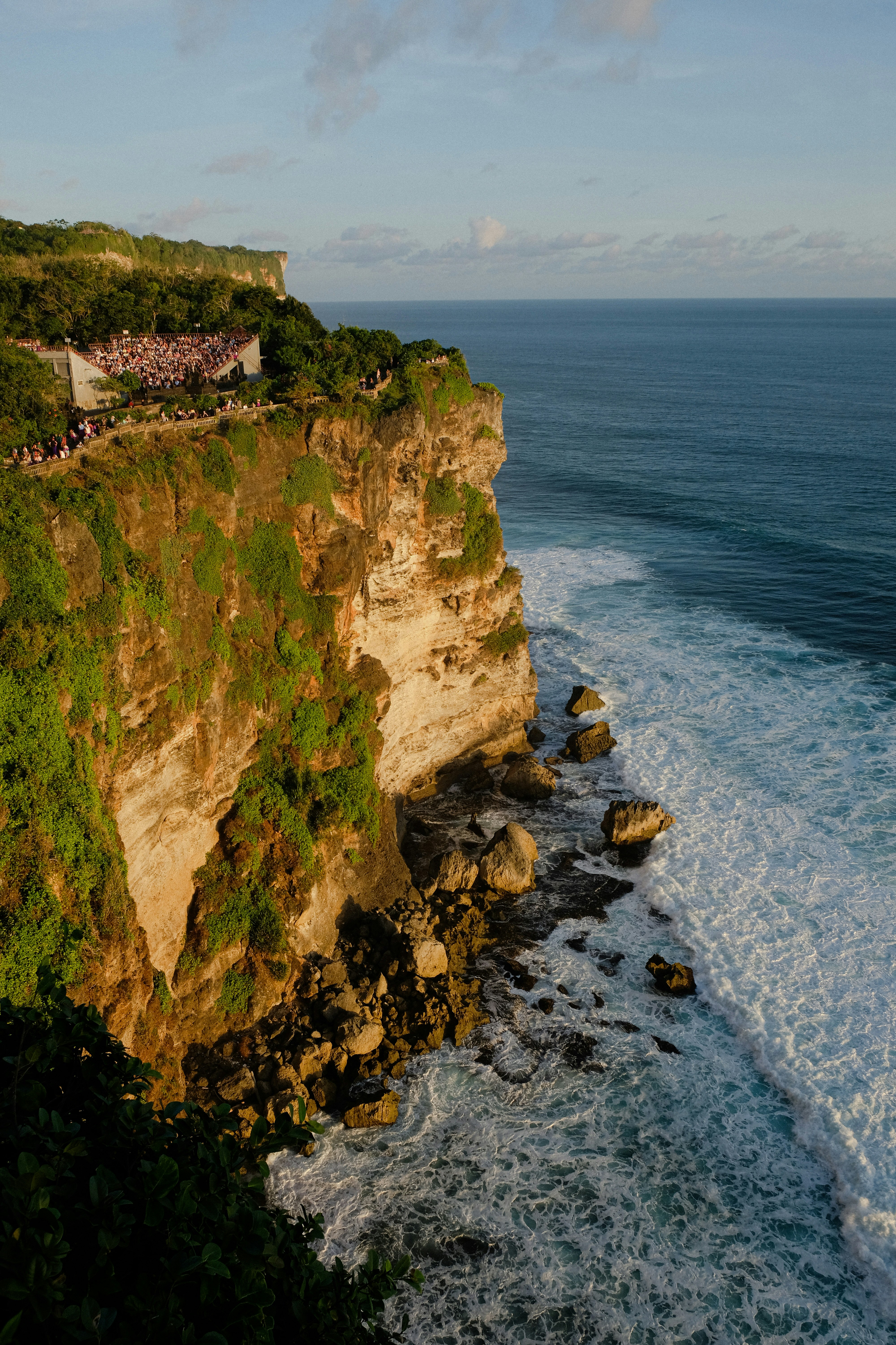 a cliff overlooking the ocean with people on it