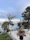 A peaceful lakeside garden with blooming flowers and comfortable seating.