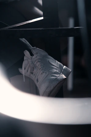 Close-up of a modern sneaker against a clean white background with green accents