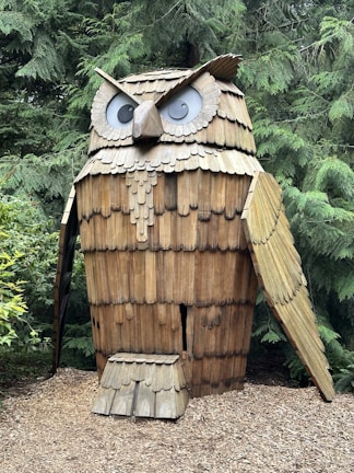 Nature-themed wall decor showcasing a layered owl design in natural wood shades.