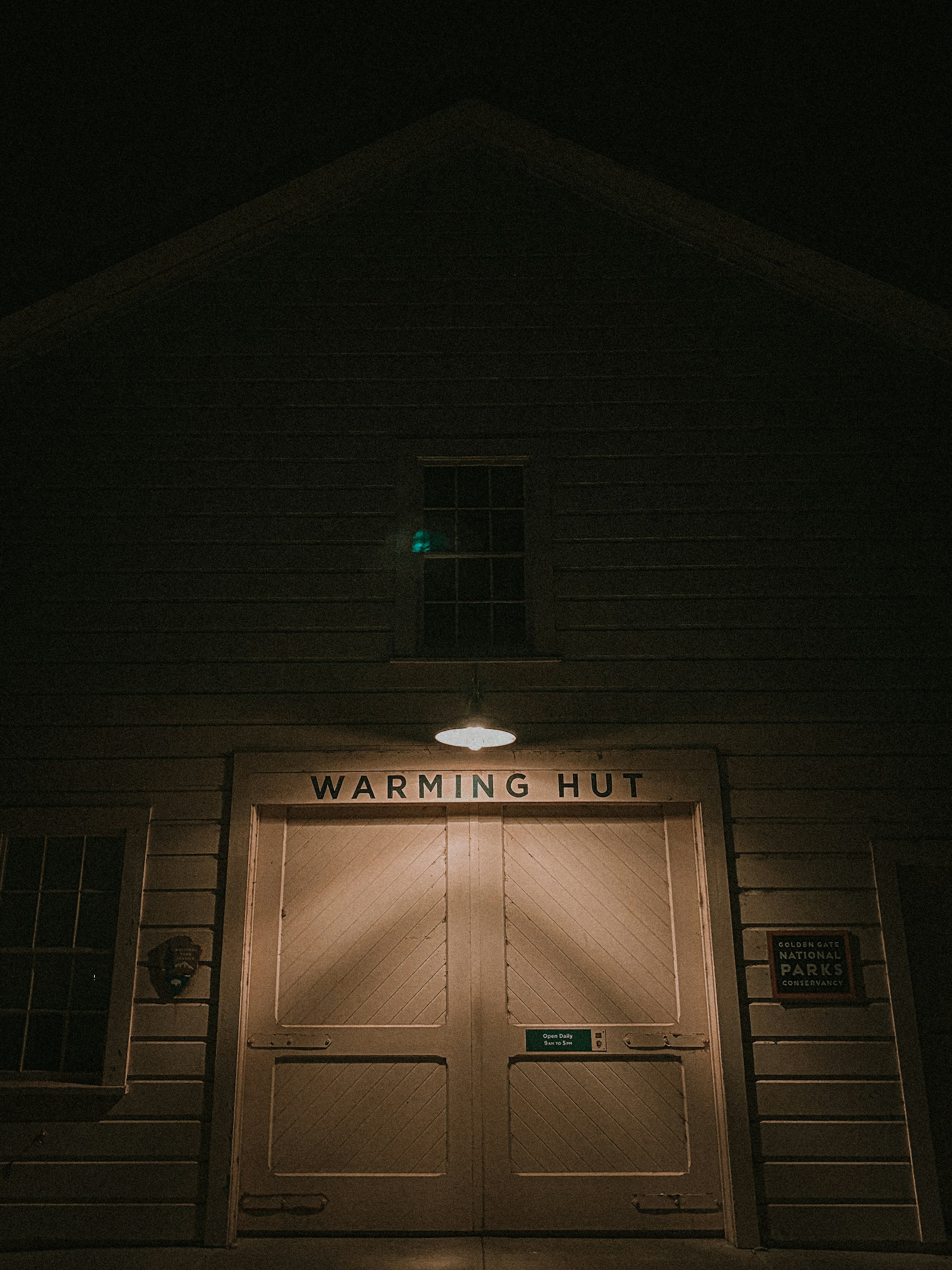 the front of a building with a lit up door