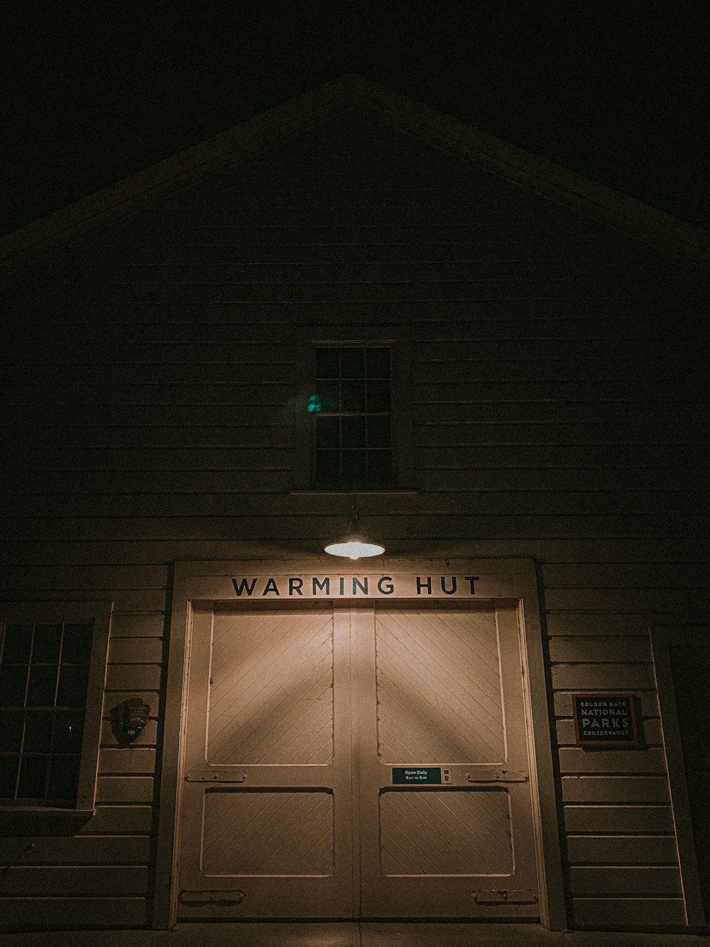 the front of a building with a lit up door