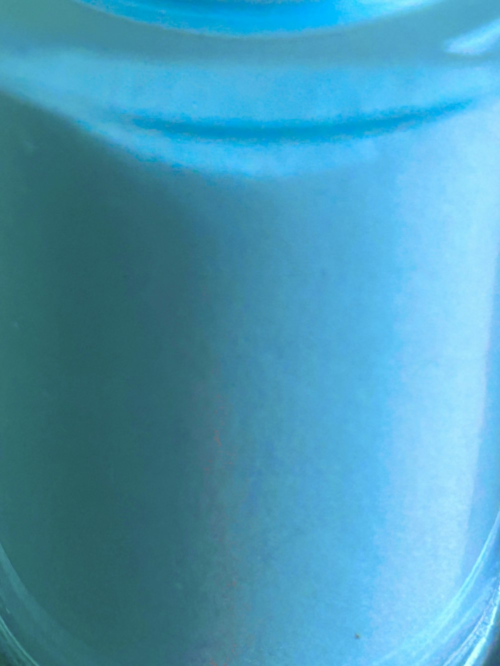 a close up of a blue jar on a table