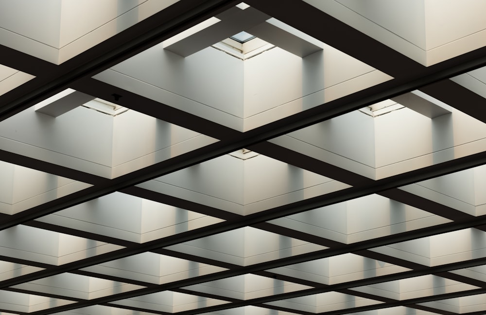 the ceiling of a building with many square lights