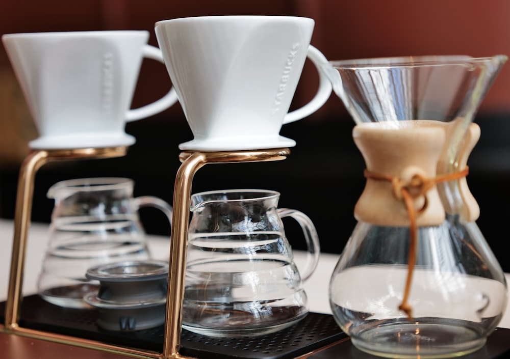 a coffee maker with a carafe pouring coffee into it