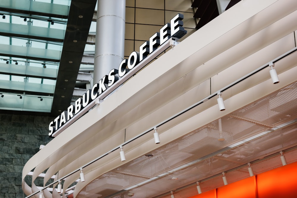 a starbucks sign on the side of a building