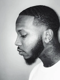 Side profile of a client with a perfectly groomed beard and sharp neckline.