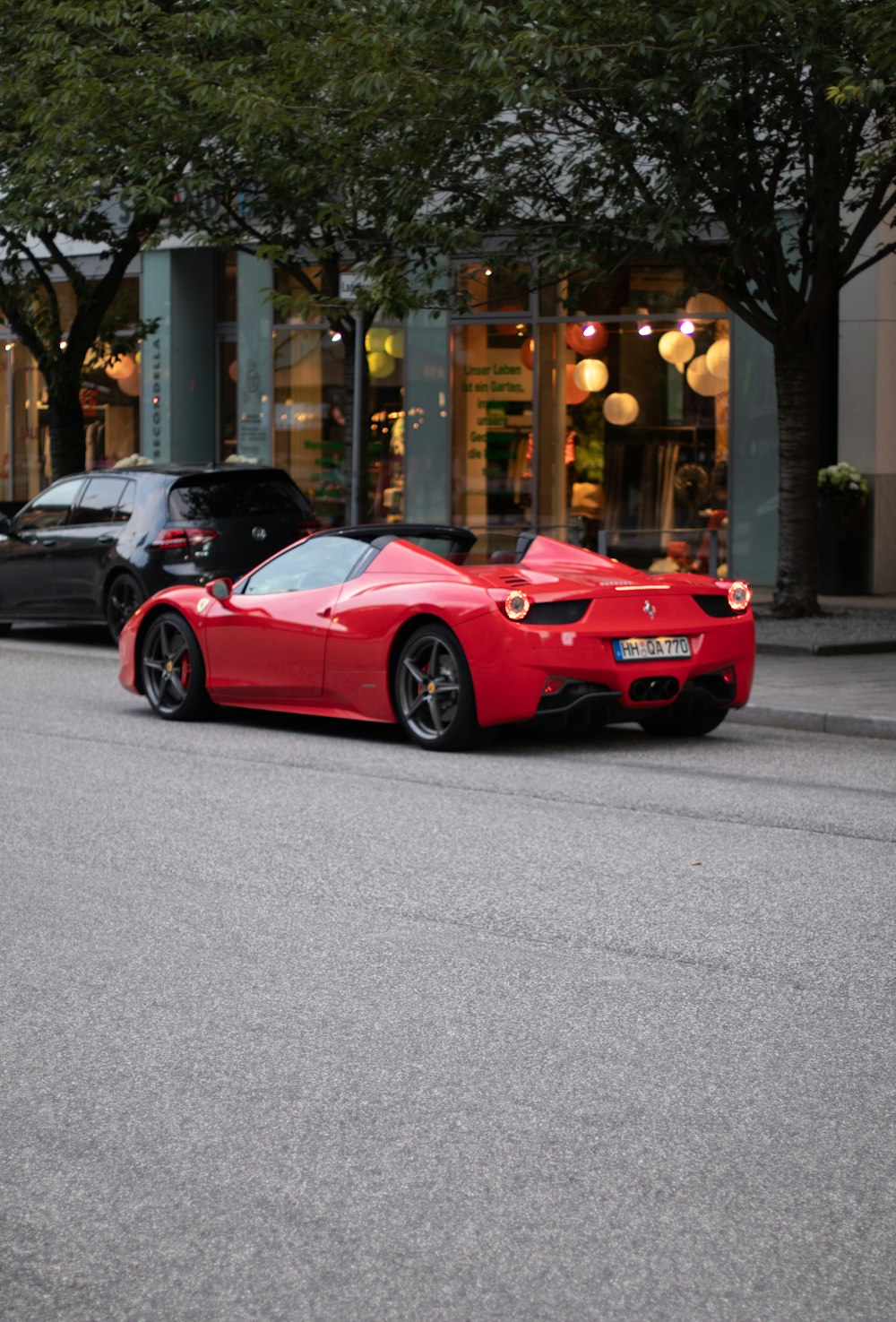 a red sports car parked on the side of the road