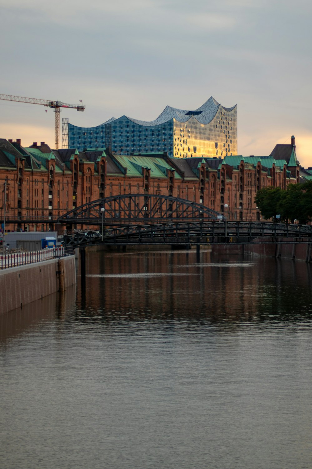 a bridge over a body of water with a building in the background