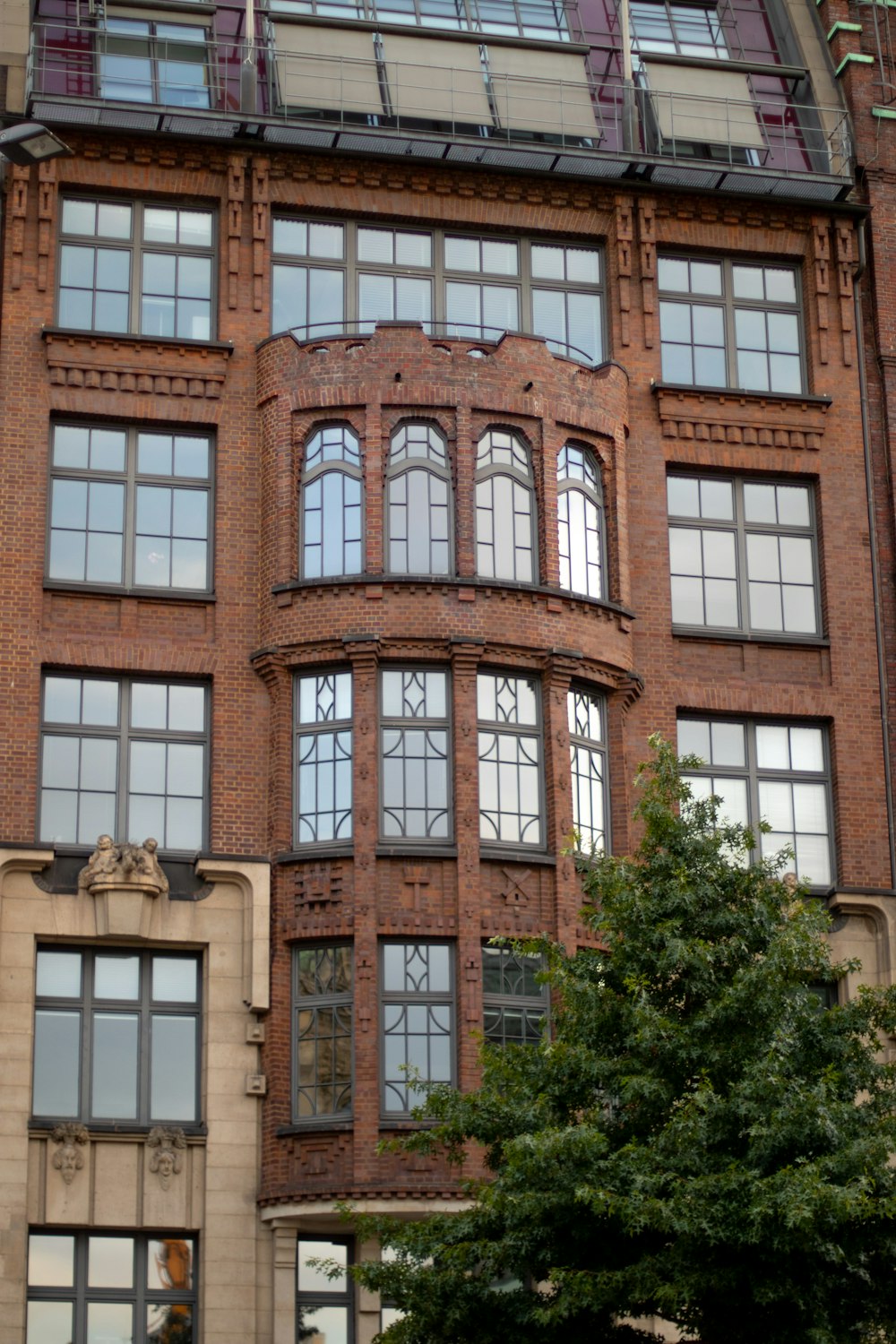 a large brick building with a clock on the front of it