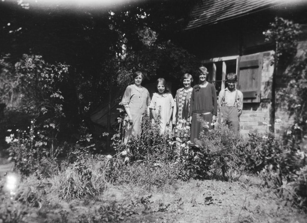 a group of people standing in front of a house