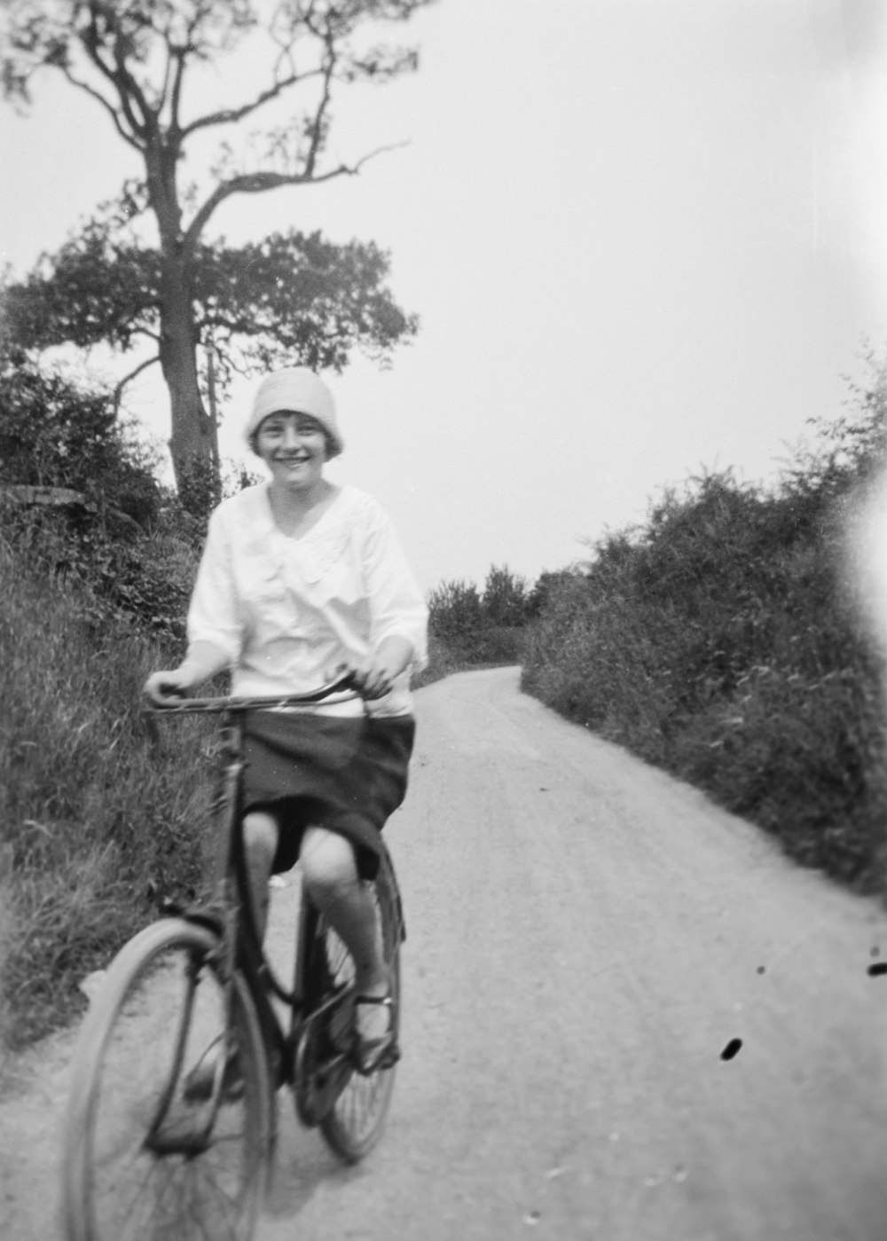 a man riding a bike down a dirt road