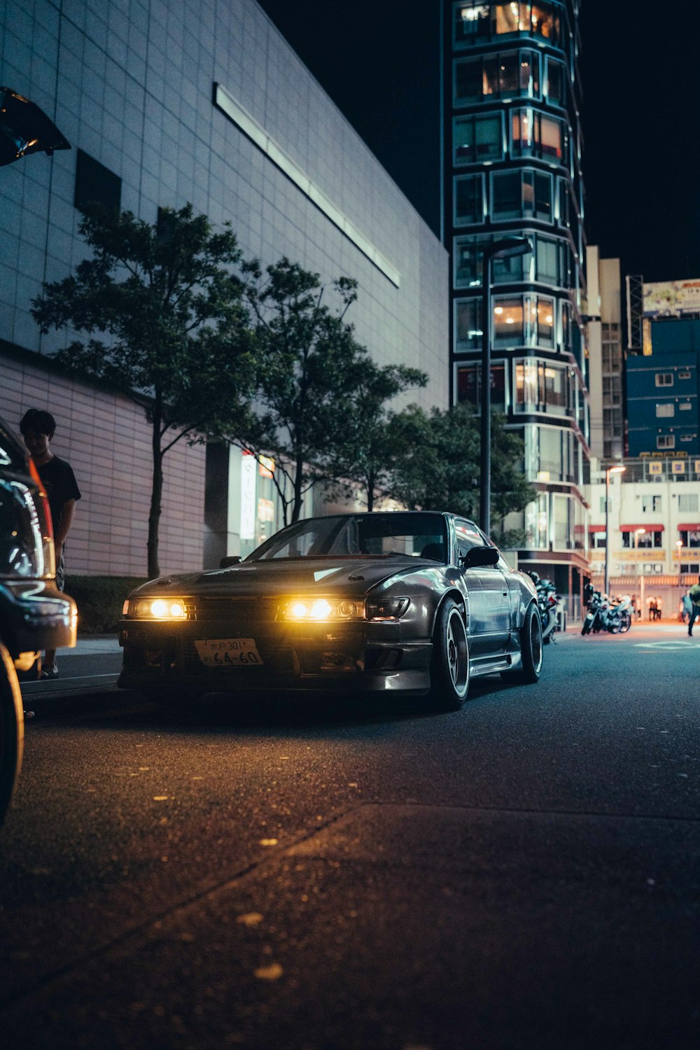 a car parked in front of a tall building