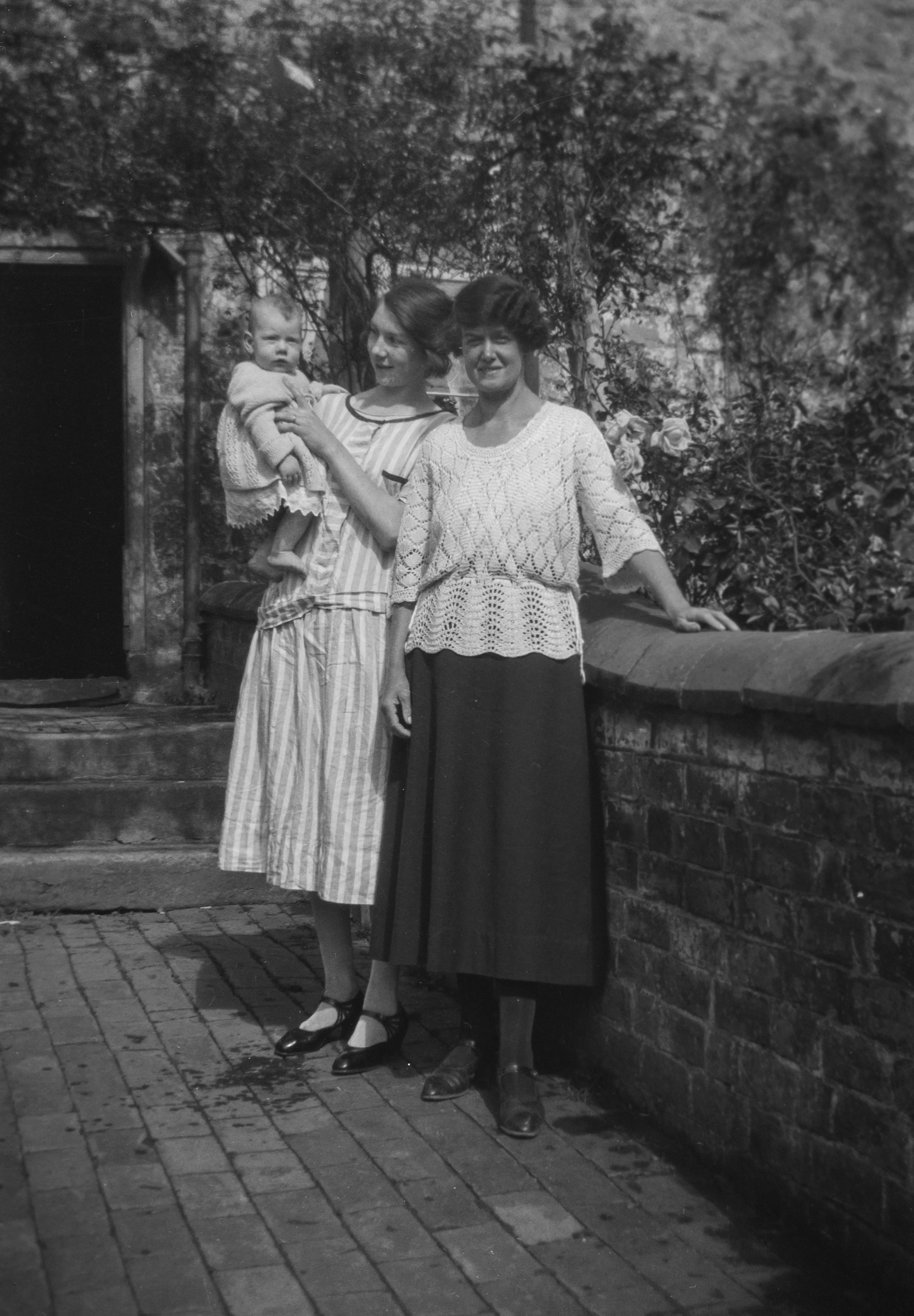an old photo of two women and a baby