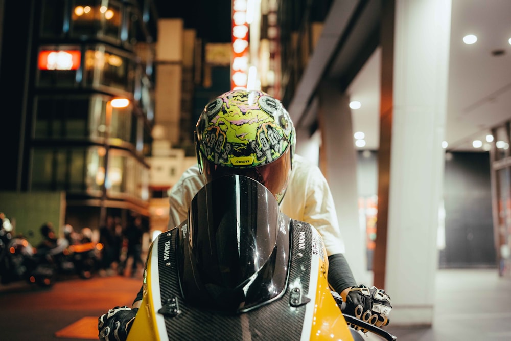 a man wearing a helmet sitting on a motorcycle
