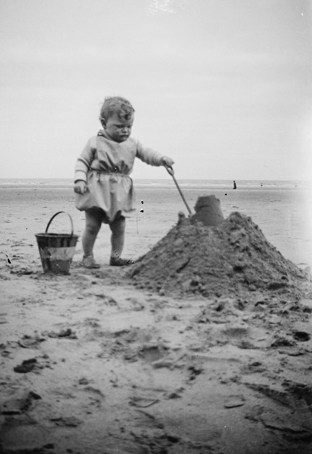 a little girl that is standing in the sand
