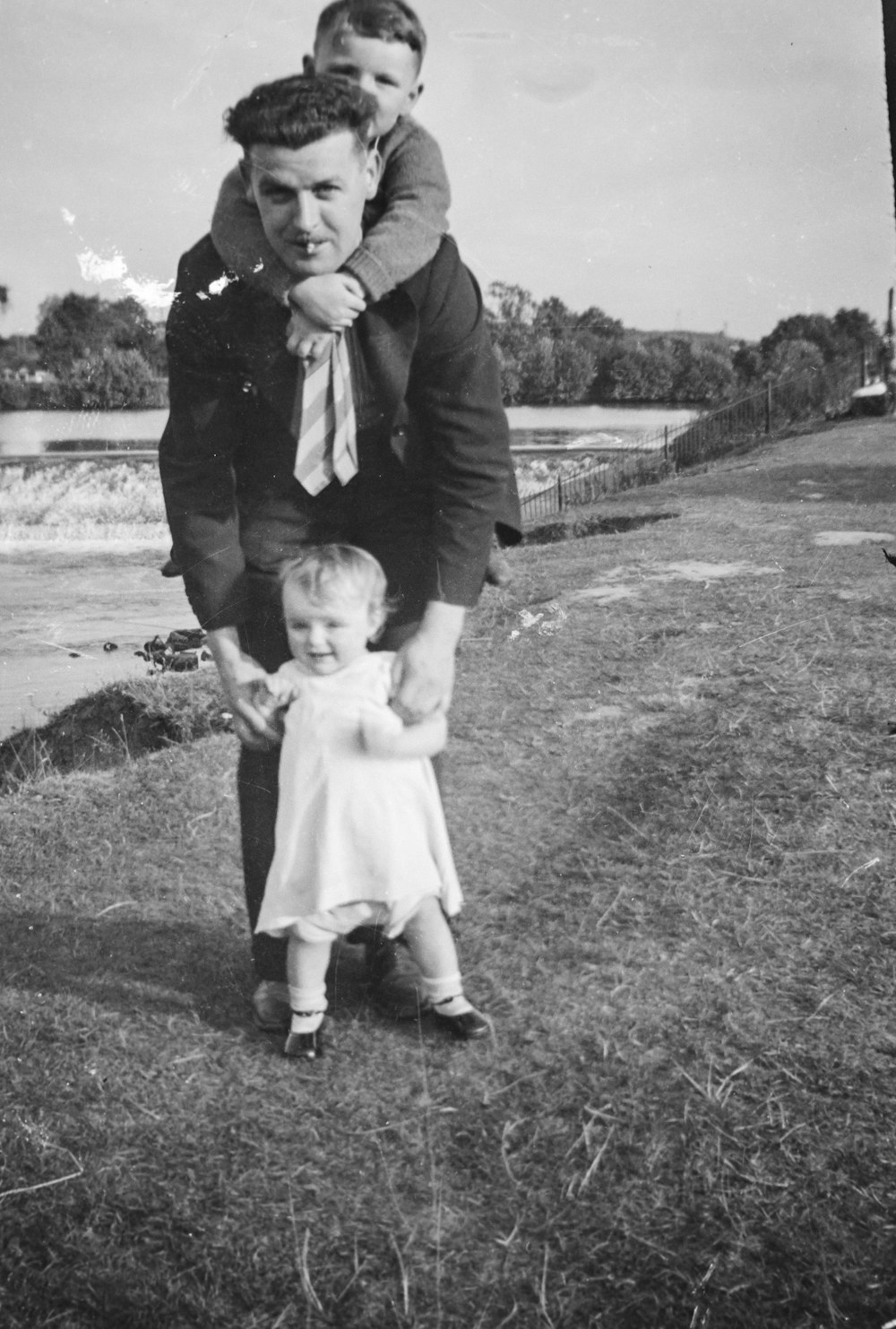 an old photo of a man holding a little girl
