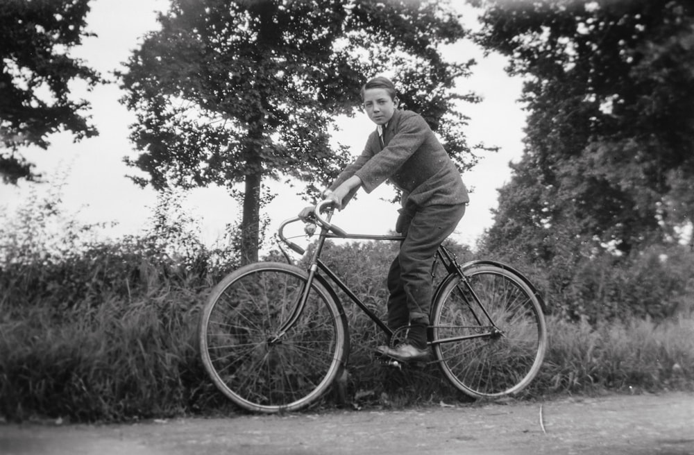 a man riding a bike down a dirt road