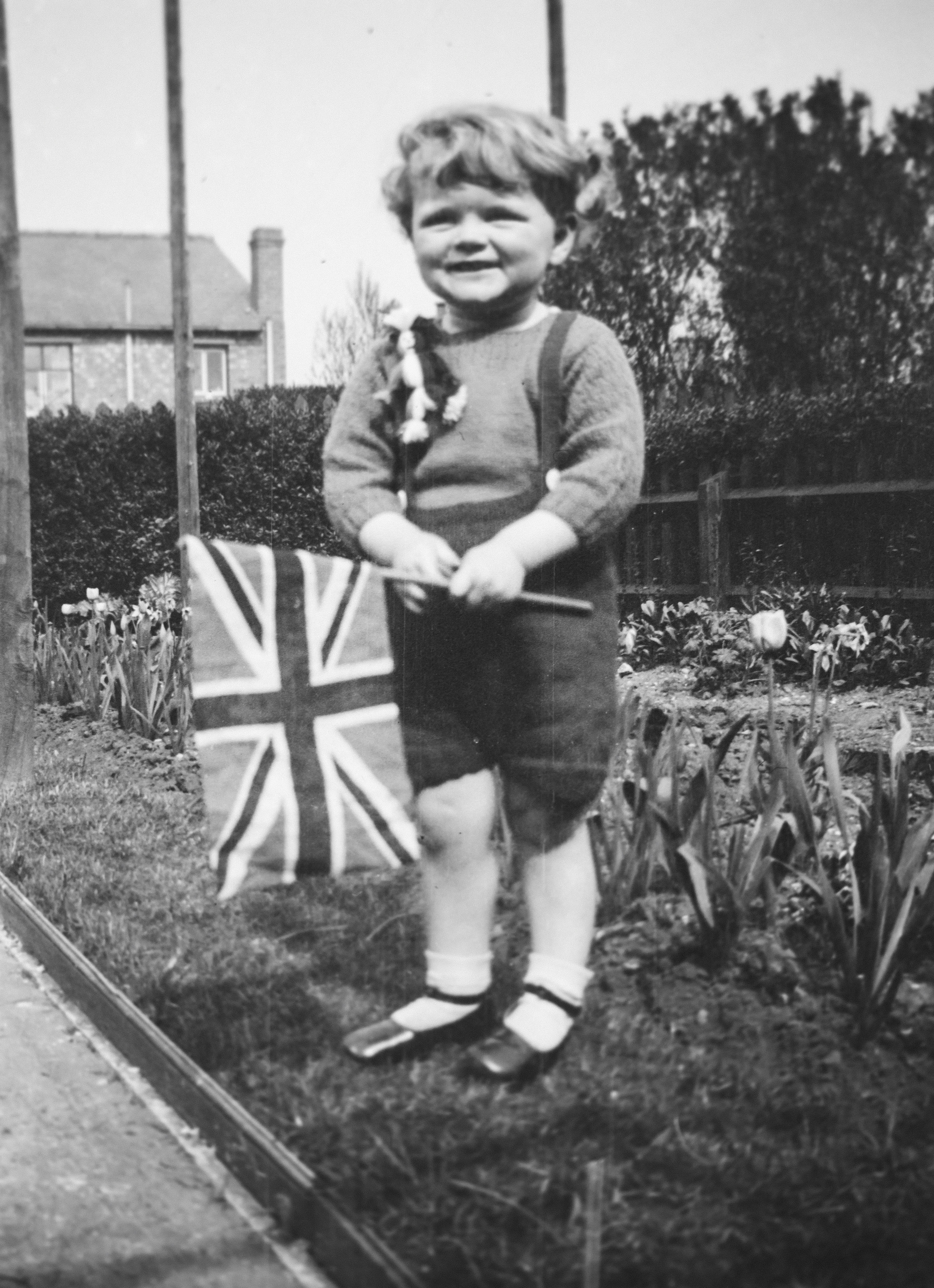 a young boy holding a union jack flag