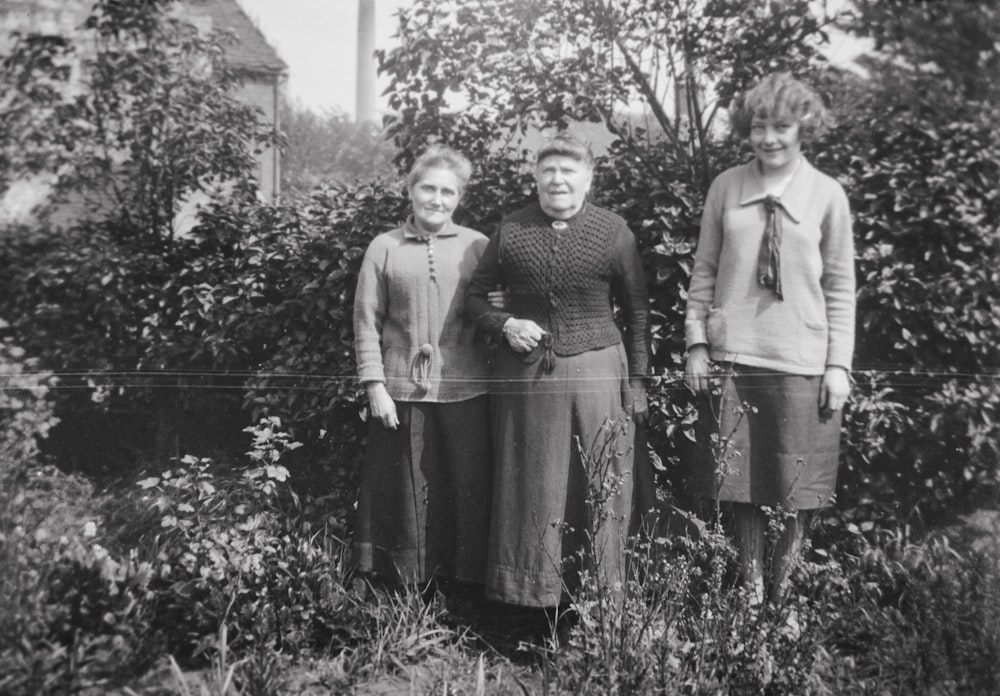 an old black and white photo of three women