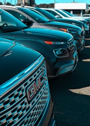 a row of cars parked next to each other in a parking lot