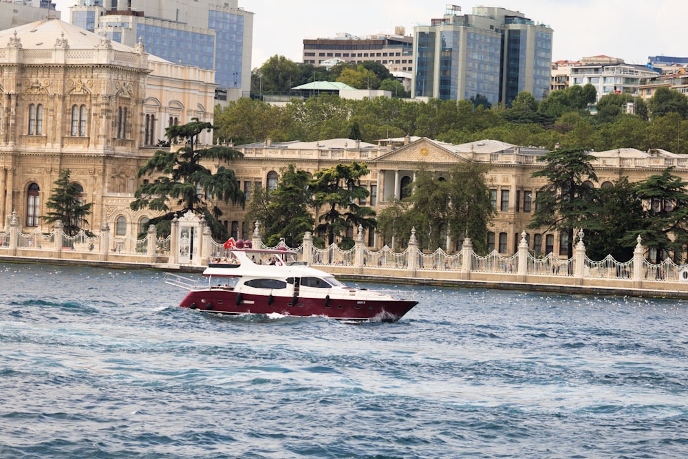 a red and white boat in a body of water